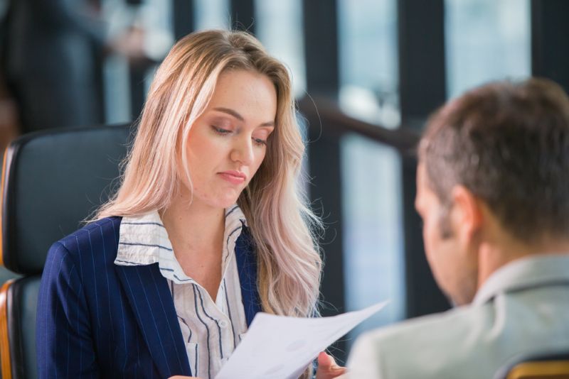 What Happens if Your Employer Disputes Your Work Injury? 1 Businesswoman reviewing paperwork in her office